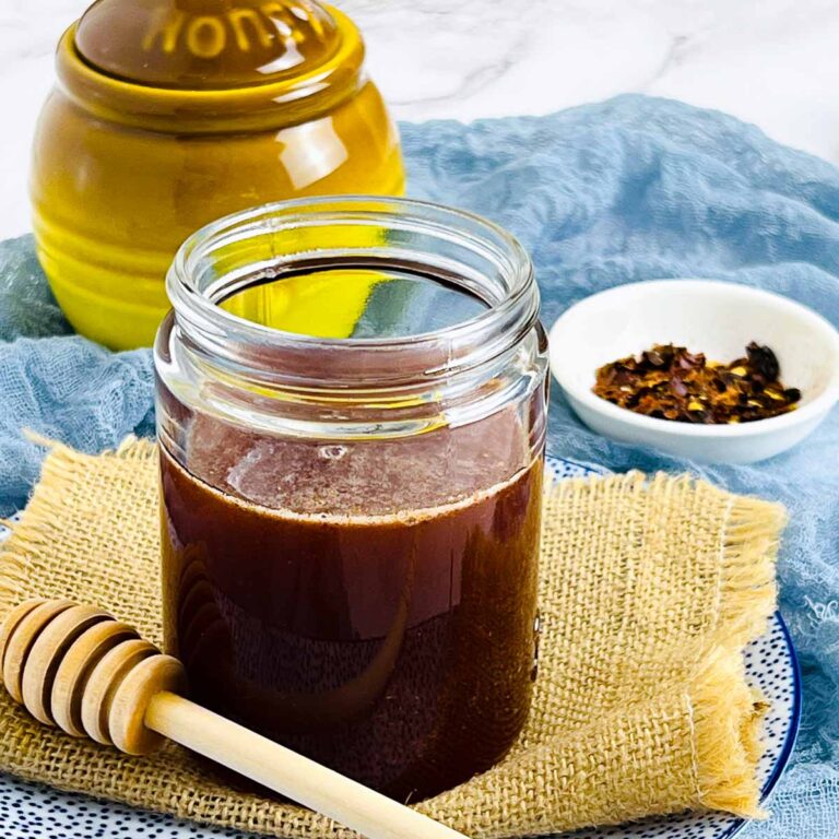 Close up of a jar full of hot honey.
