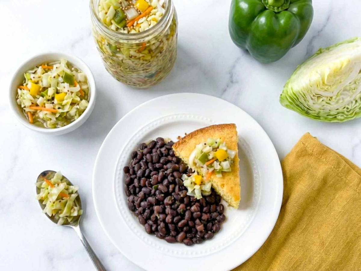 A plate of black beans and corn bread served with chow chow relish.