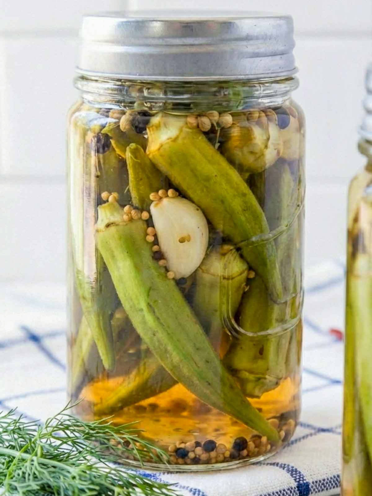 Close up of a jar of pickled okra with the lid on.